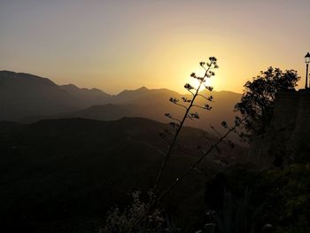 Scenic view of silhouette mountains against sky at sunset