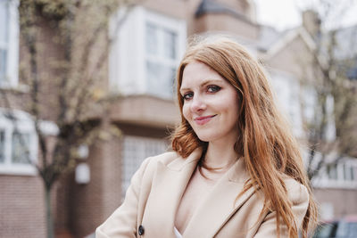 Portrait of young woman standing outdoors
