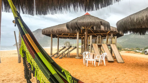 Chairs at beach against sky