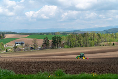 Scenic view of agricultural field against sky