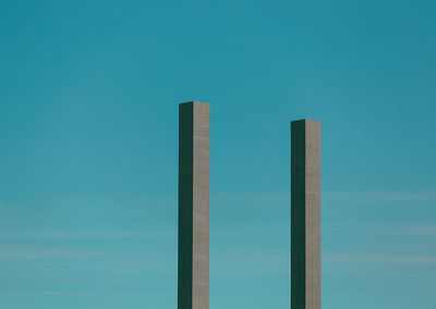 Low angle view of modern buildings against clear blue sky