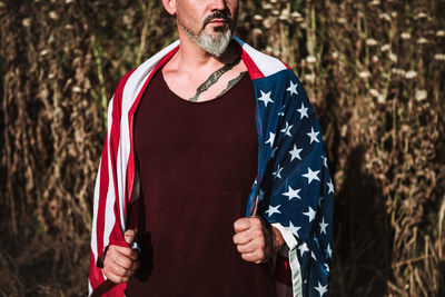 Low section of man standing at beach