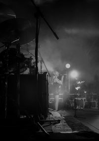 Low angle view of illuminated lighting equipment at night