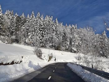 Snow covered landscape against sky