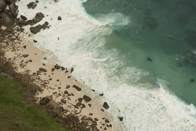 Aerial view of sea waves splashing on shore