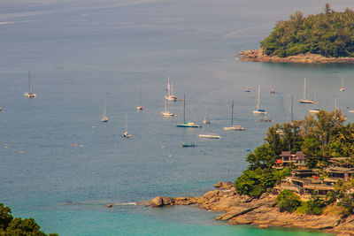 High angle view of sailboats sailing in sea against sky