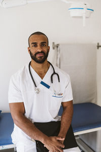 Portrait of male healthcare worker standing with medical file