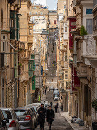 People on street amidst buildings in city