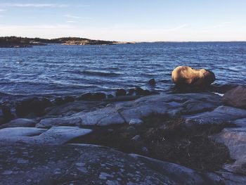 Rocks on beach against sky