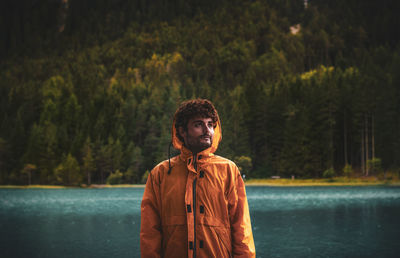 Portrait of young man looking at lake