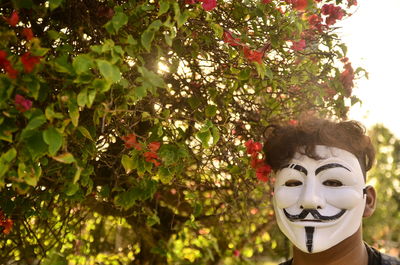 Portrait of mask on tree