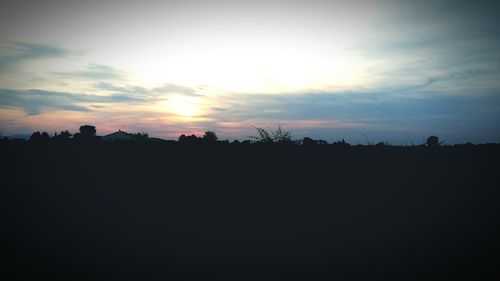 Silhouette landscape against sky during sunset