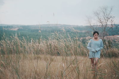 Young woman standing on field