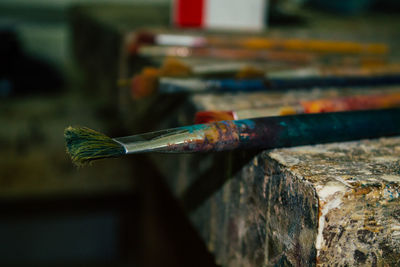 Close-up of paintbrushes on rusty metal