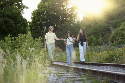 Rear view of couple walking on footpath