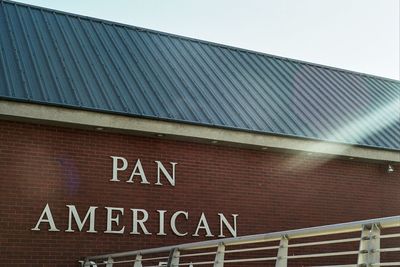 Low angle view of text on building against sky