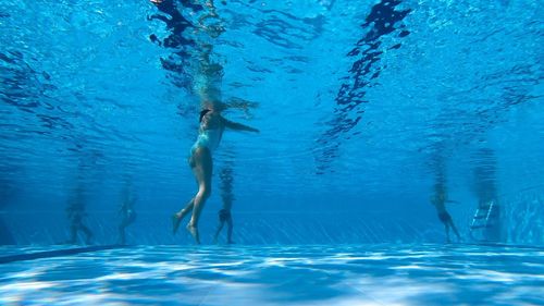 Low section of girl swimming in pool