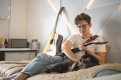 Man playing guitar at home