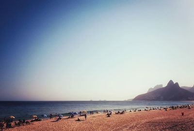 View of calm beach against blue sky