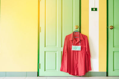 Shirt and mask hanging on door