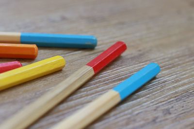 High angle view of pencils on wooden table