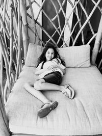 High angle portrait of girl lying on bed