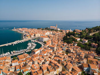 High angle view of townscape by sea against sky