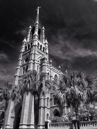 Low angle view of building against cloudy sky