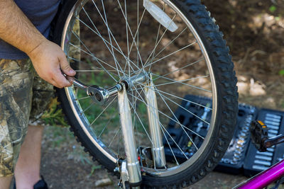 Low section of person with bicycle on metal