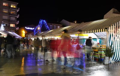 People on wet street during rainy season at night