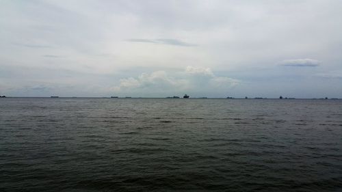 Scenic view of sea against cloudy sky