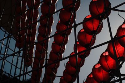 Low angle view of lanterns hanging against sky at dusk