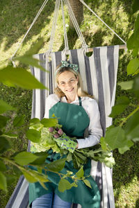 Young woman sitting on swing