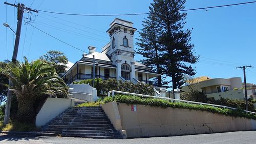 Low angle view of staircase by building against clear sky