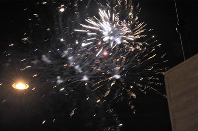 Low angle view of firework display at night