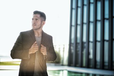 Confident man looking away in city