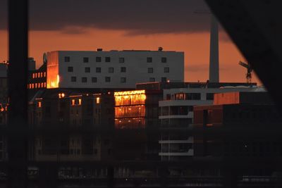 Buildings against sky at sunset