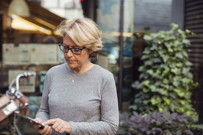 Young man using mobile phone outdoors