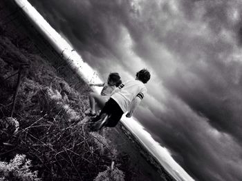 Full length of woman standing against sky