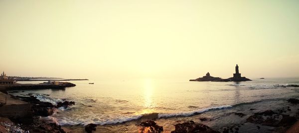 Scenic view of sea against clear sky during sunrise