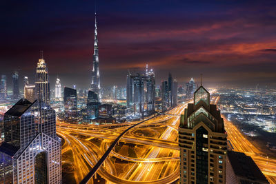 Illuminated cityscape against sky at night