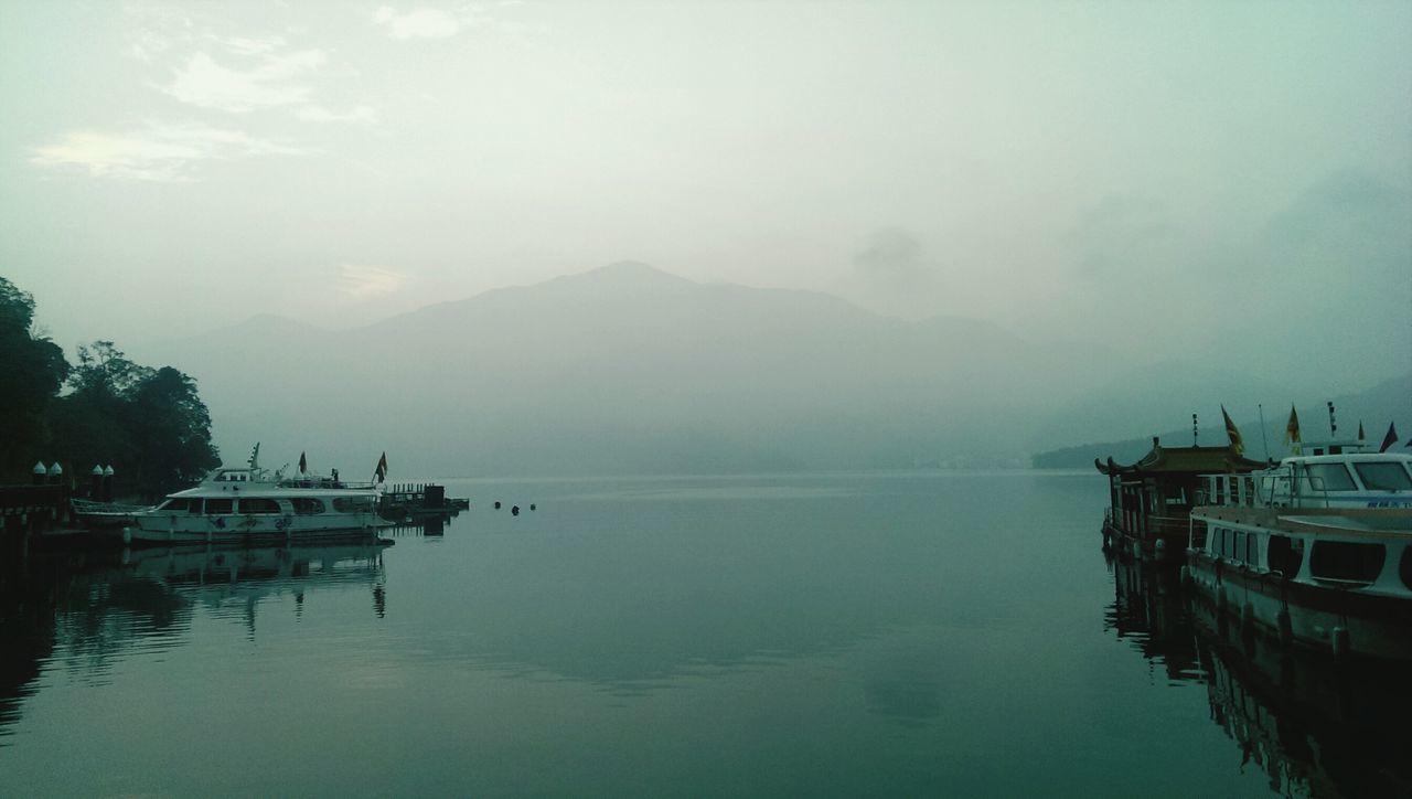 nautical vessel, water, transportation, boat, mode of transport, moored, sky, waterfront, tranquil scene, tranquility, scenics, mountain, beauty in nature, sea, nature, lake, cloud - sky, reflection, travel, idyllic