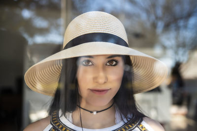 Portrait of smiling young woman wearing hat