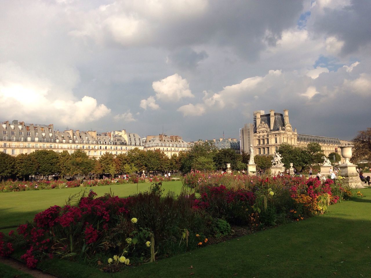 flower, sky, architecture, building exterior, built structure, grass, cloud - sky, tree, cloud, growth, freshness, plant, lawn, cloudy, park - man made space, nature, beauty in nature, green color, field, formal garden