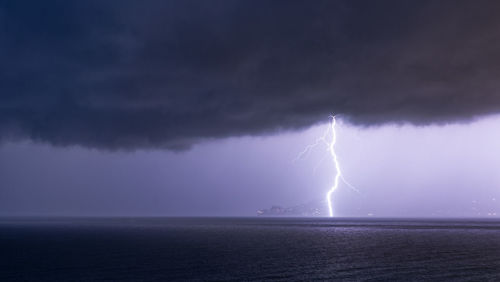 Lightning over sea against sky