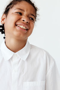 Portrait of young woman against white background