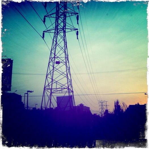 transfer print, power line, electricity pylon, power supply, electricity, sky, connection, low angle view, auto post production filter, silhouette, fuel and power generation, cable, built structure, technology, sunset, architecture, power cable, cloud - sky, building exterior, outdoors