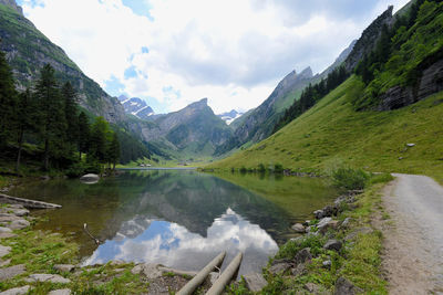 Scenic view of lake and mountains against sky