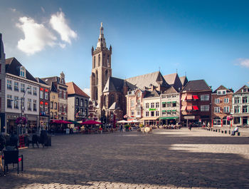 Buildings in city against blue sky