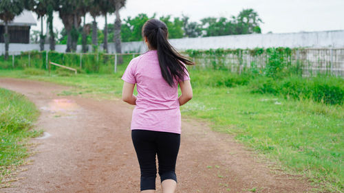 Rear view of woman walking in park